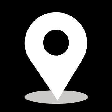 White map pin icon on a black background