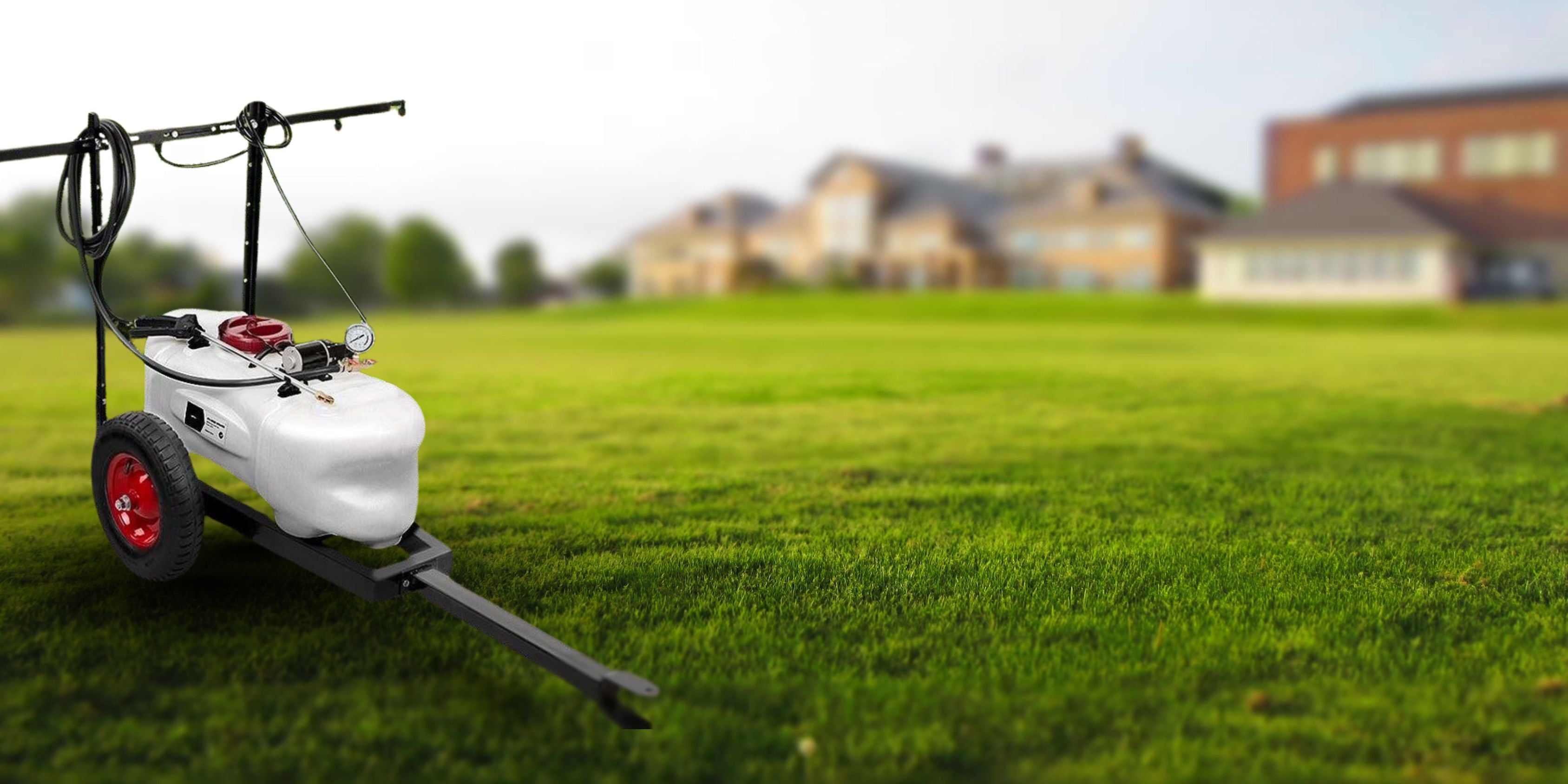 White pressure washer on a grassy lawn with houses in the background - with JD Trailer Hire Spray Trailerslider_item_iDjnzA