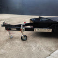 Trailer Hire Brisbane - Black trailer with JD Trailer Hire branding on a concrete surface.