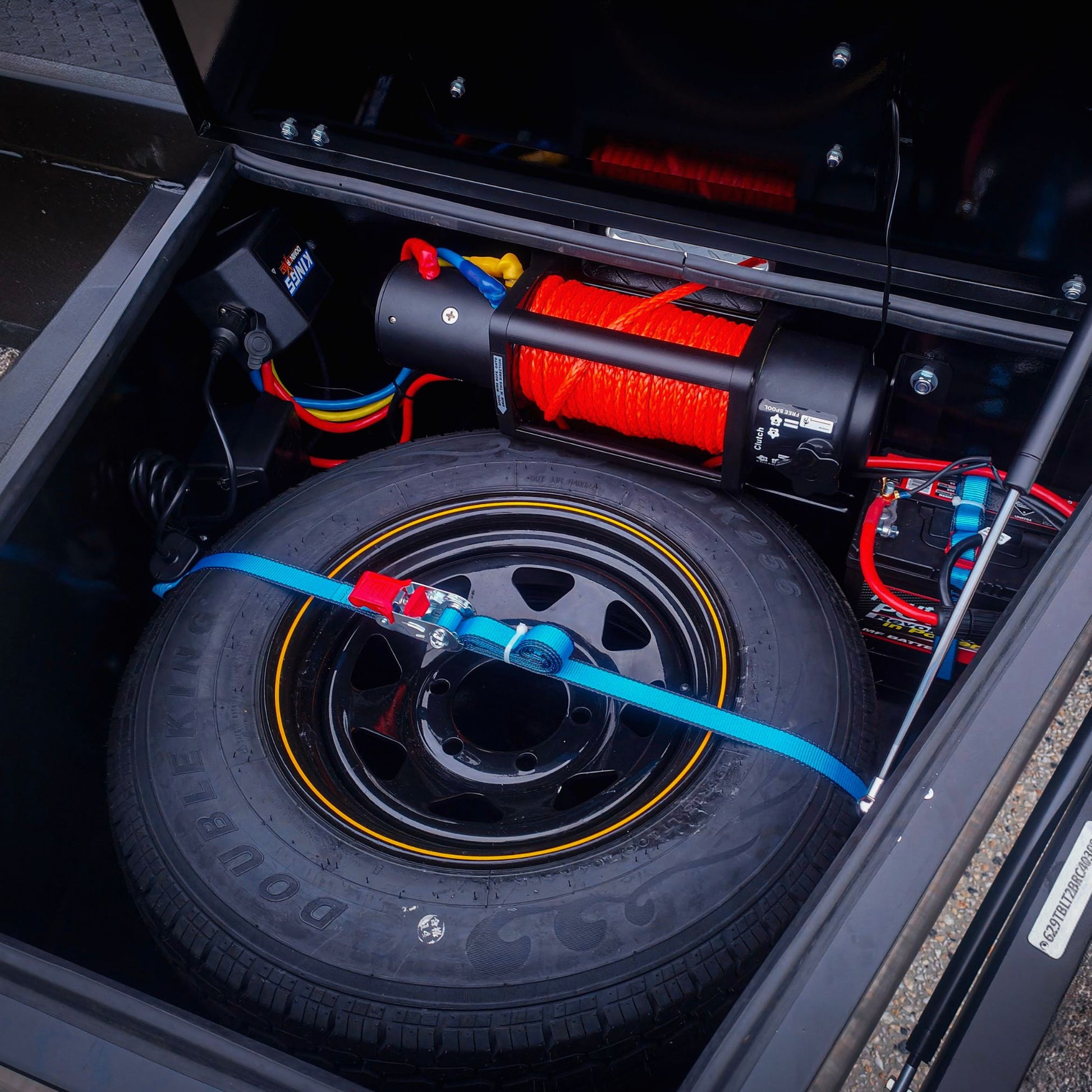 Trailer Hire Brisbane - Tire and winch setup inside a vehicle's open cargo area