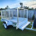 cage trailer hire Brisbane​ - Metal trailer with a cage on a grassy area