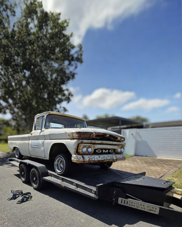 Project car loaded on car trailer hire for restoration transport